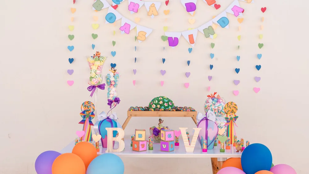 Vibrant and festive baby shower setup with balloons and decorations.