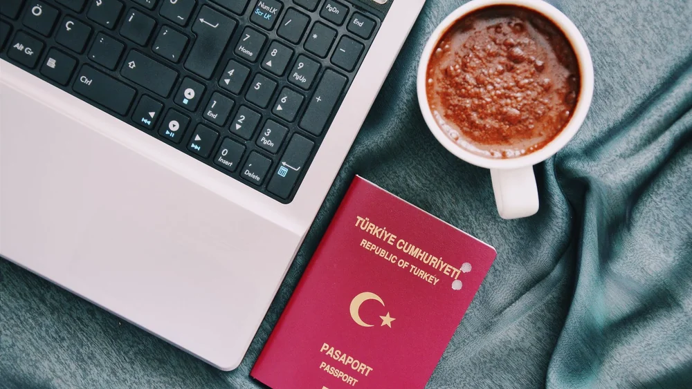 A laptop and passport, the setup for working away from your usual base