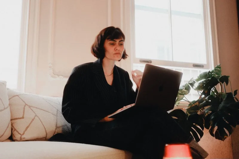 Someone working at a laptop in a home office