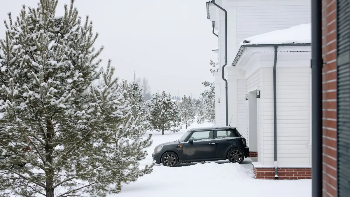 A car parked on a driveway outside a house