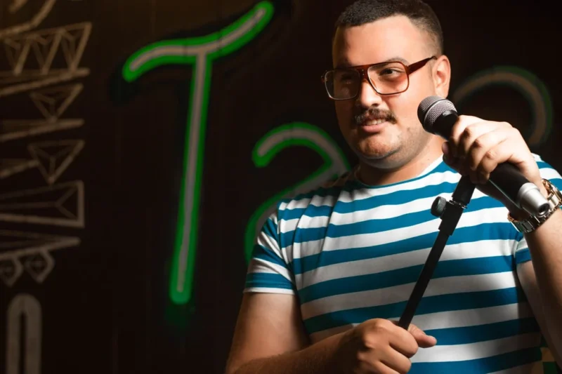 A microphone on a lit comedy club stage