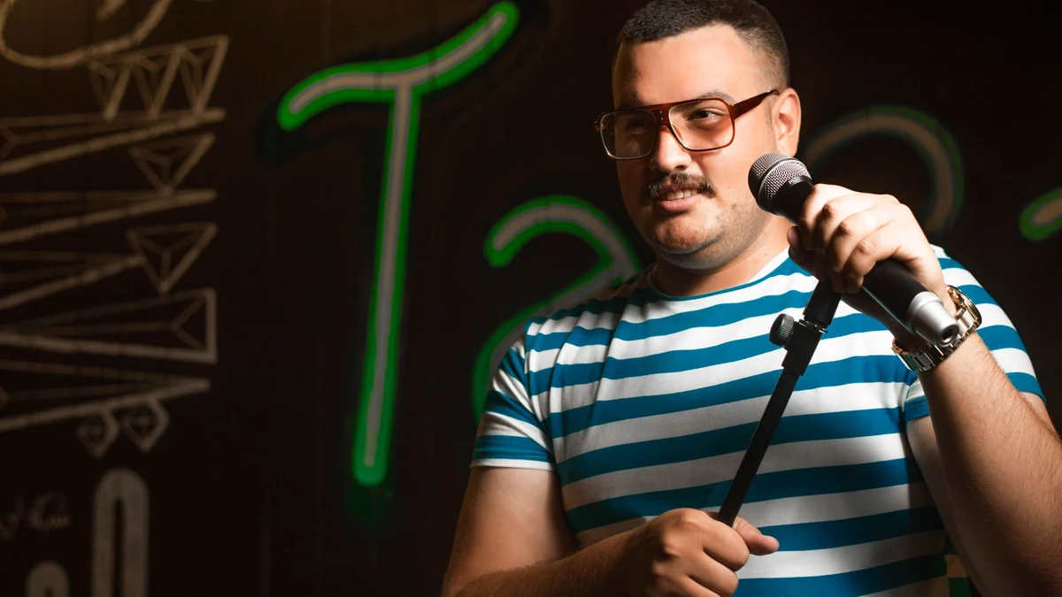A microphone on a lit comedy club stage