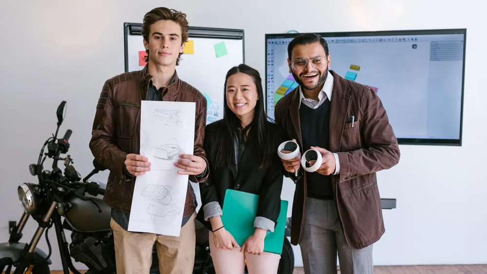 Diverse young entrepreneurs showcasing a new product prototype in a modern office.