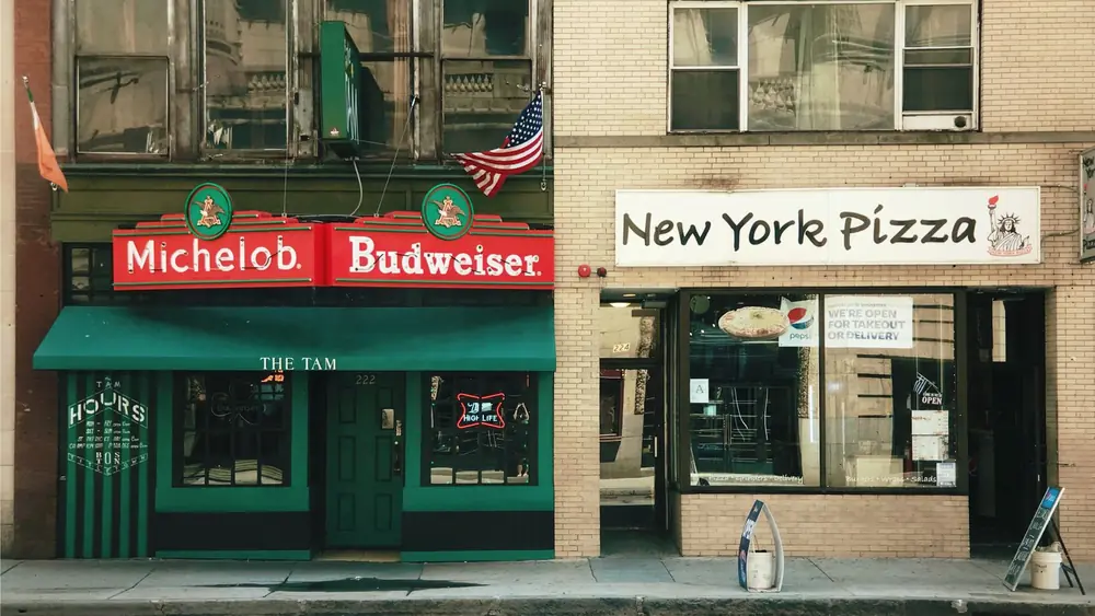 Photo of bar and pizza shop on a Boston street highlighting urban life.