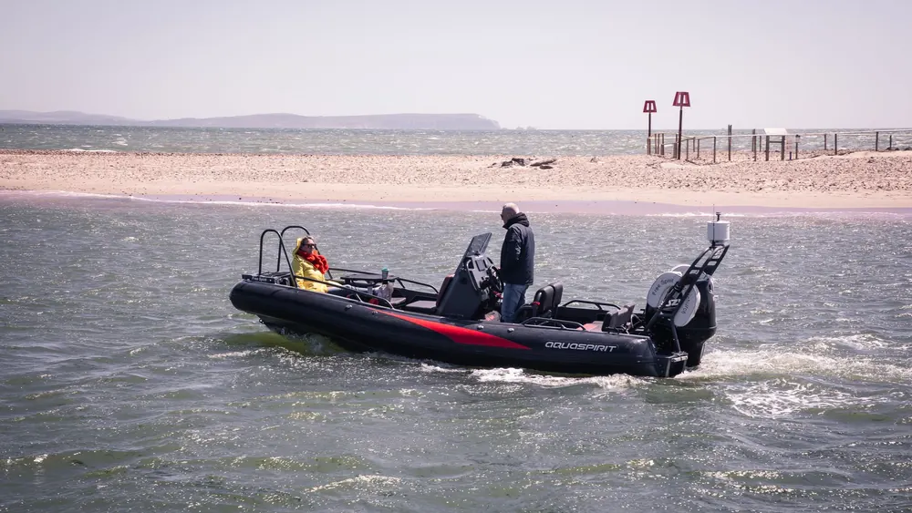 A rigid inflatable boat crossing rough open water