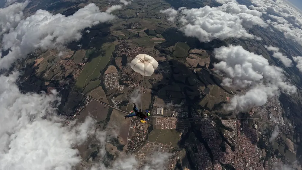 A parachute open against open sky
