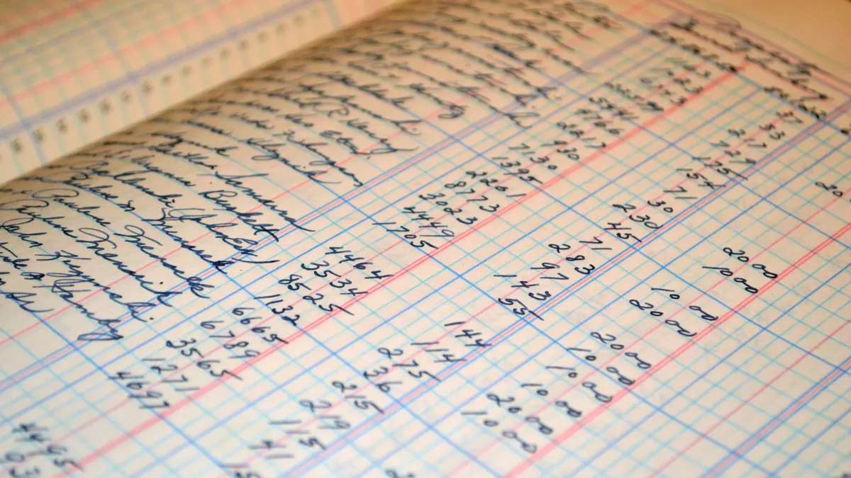 Receipts and a ledger used for small business bookkeeping