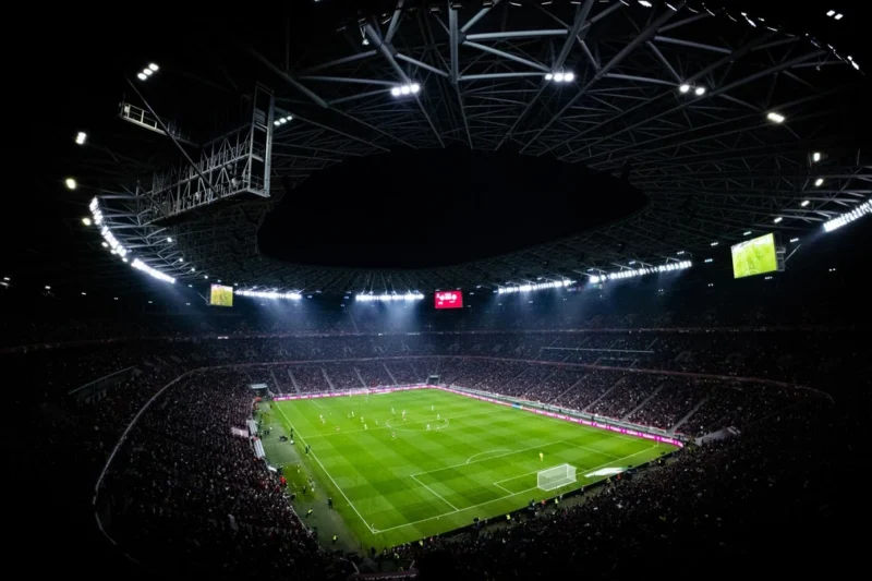 A floodlit football stadium on a match night