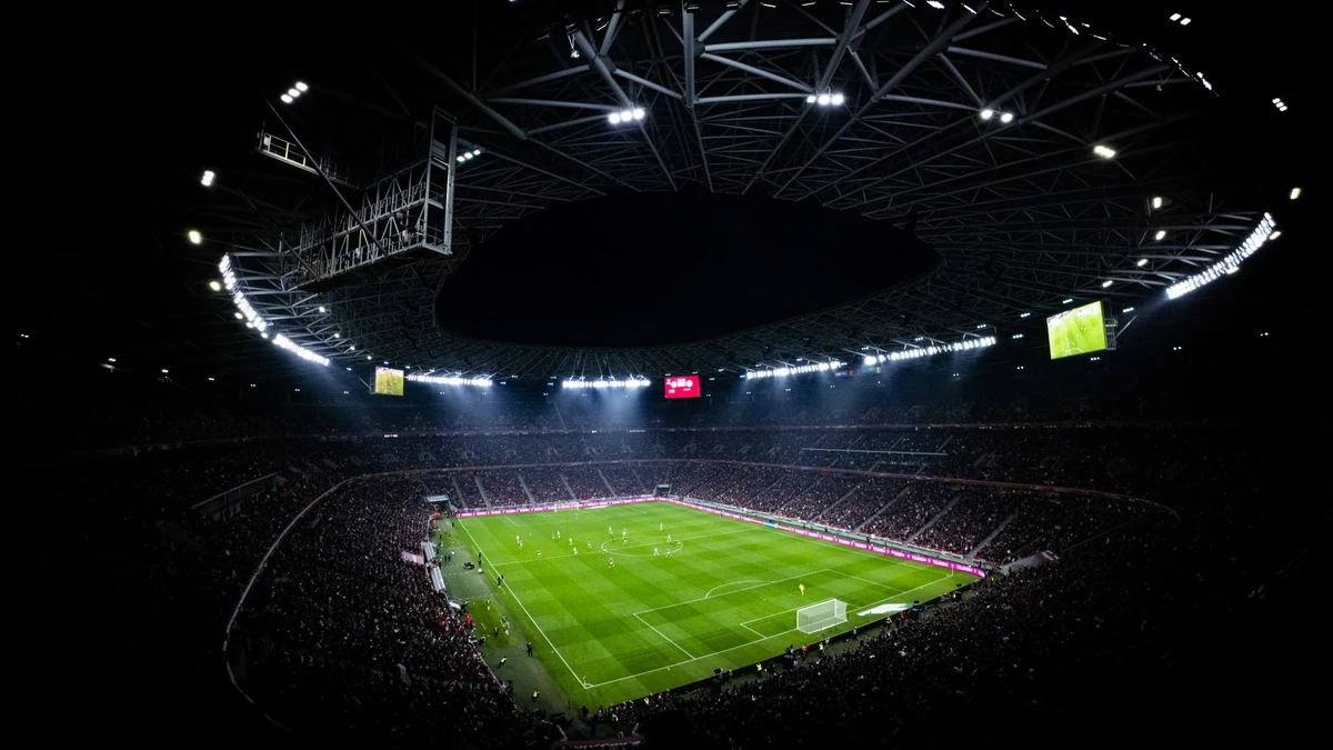 A floodlit football stadium on a match night