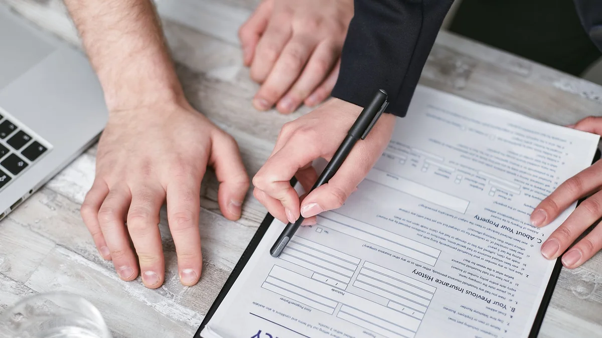 An insurance policy document being reviewed before signing