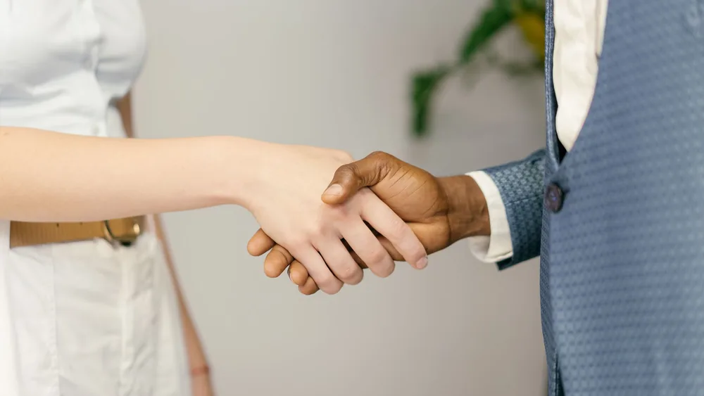 Close-up of a professional handshake symbolizing agreement and partnership in business.