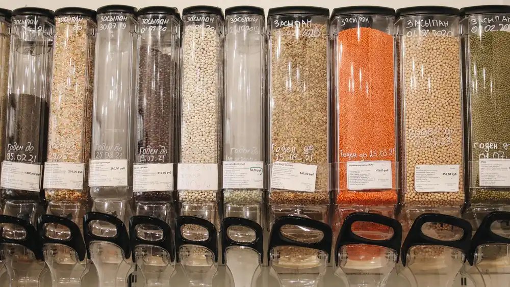 Row of eco-friendly bulk food dispensers in a shop promoting zero waste shopping.