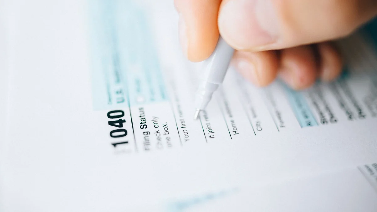 A tax return form being completed by a company director