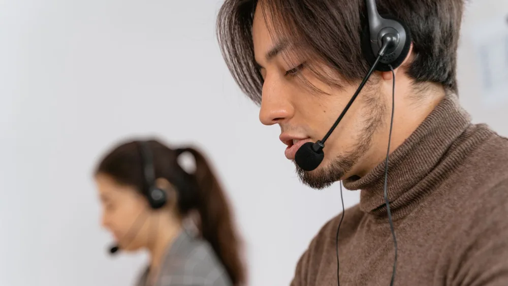 Focused call center employees wearing headsets, assisting customers with exceptional service.