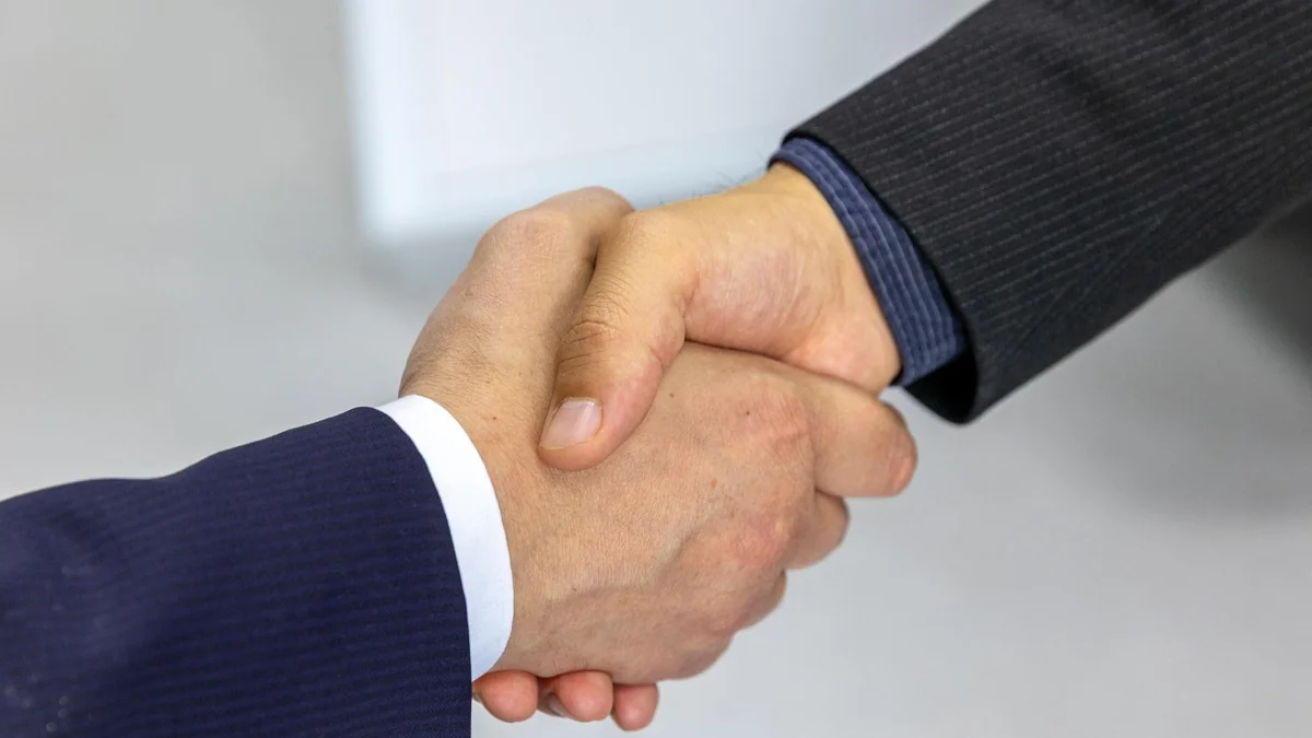 A handshake closing a business sale