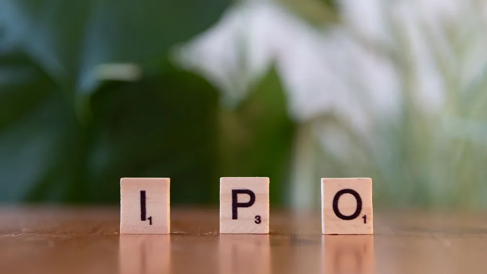 Wooden letter blocks spelling IPO on a table, symbolizing investment opportunities.