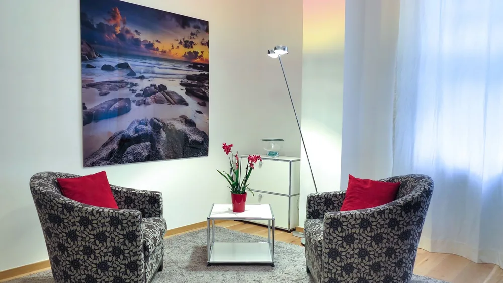 Elegant living room showcasing modern chairs, art, and decor for a stylish home setup.