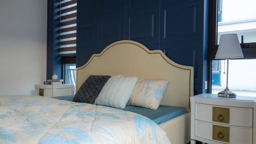Stylish bedroom with a chic blue accent wall and elegant furnishings