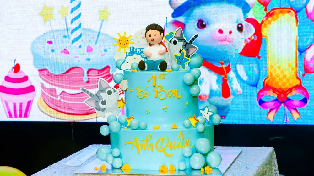 Vibrant 1st birthday cake with cartoon decorations and bright colors.
