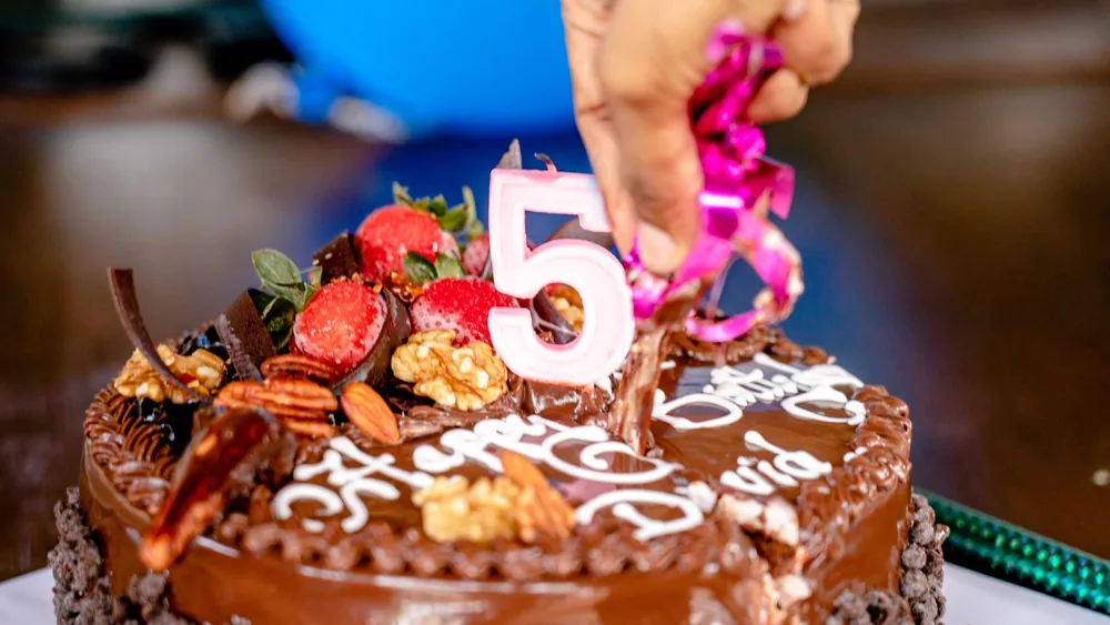 Close-up of a decorated chocolate cake for a 5th birthday celebration.
