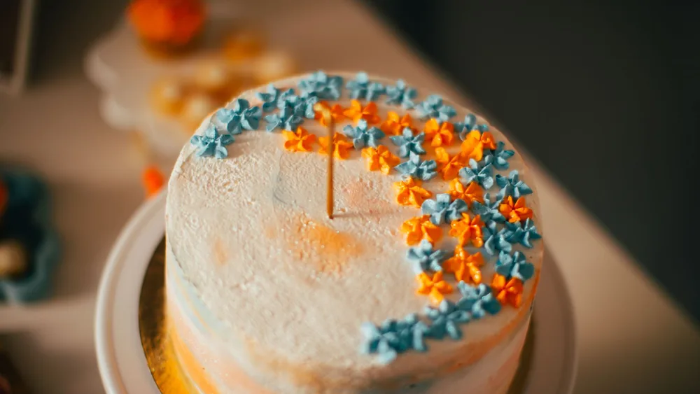 Close-up of a decorated cake with colorful floral designs, perfect for celebrations.