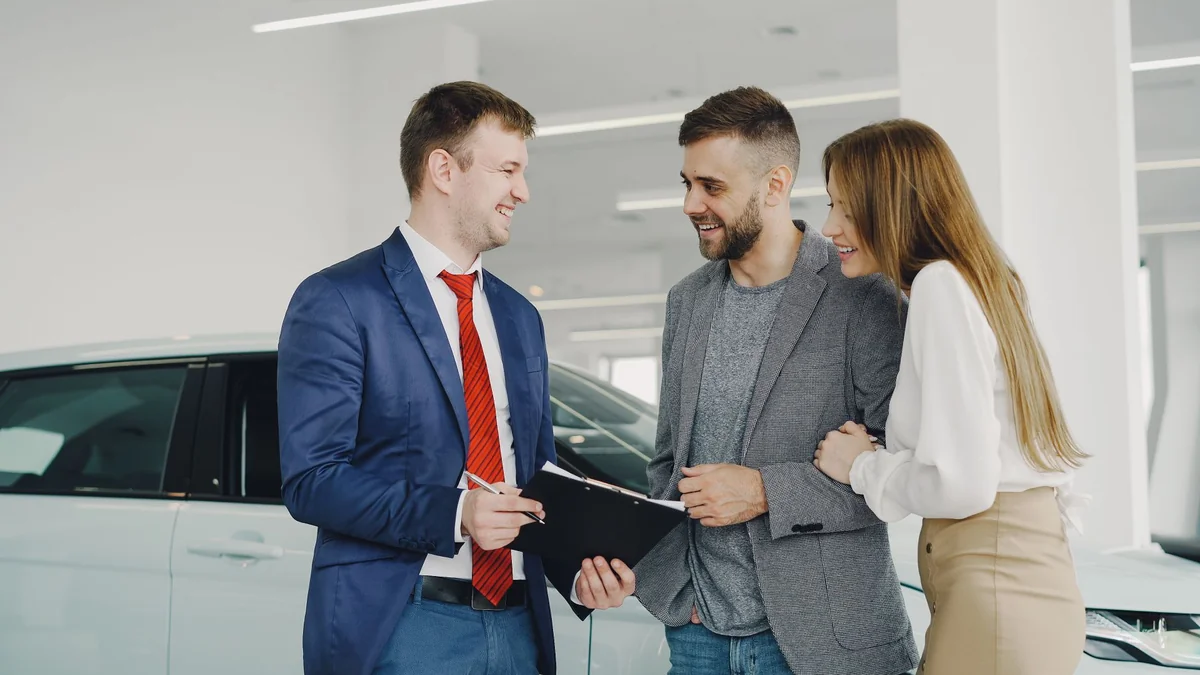 A customer in a car dealership showroom