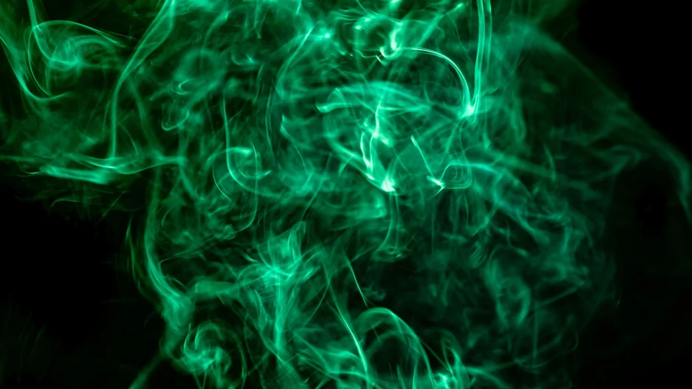 Green smoke curling through darkness, the colour of the Emerald City and of Morrible's final costumes