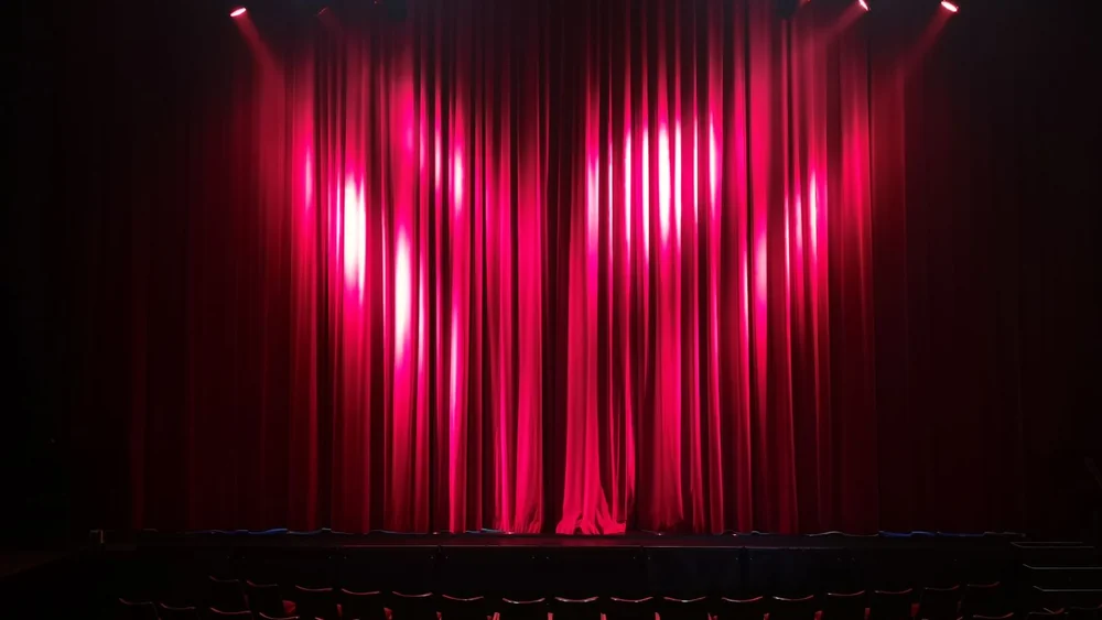 An empty theatre stage, where the role was originated on Broadway
