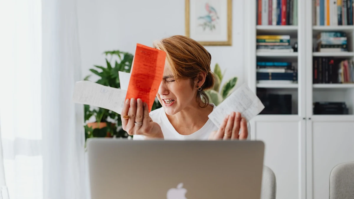 Receipts and a laptop on a desk, the raw material of digital record keeping