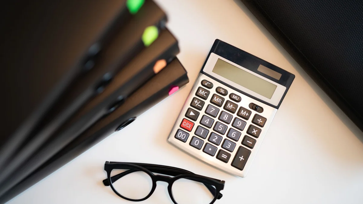 A calculator and figures used to work out gross and net profit margins