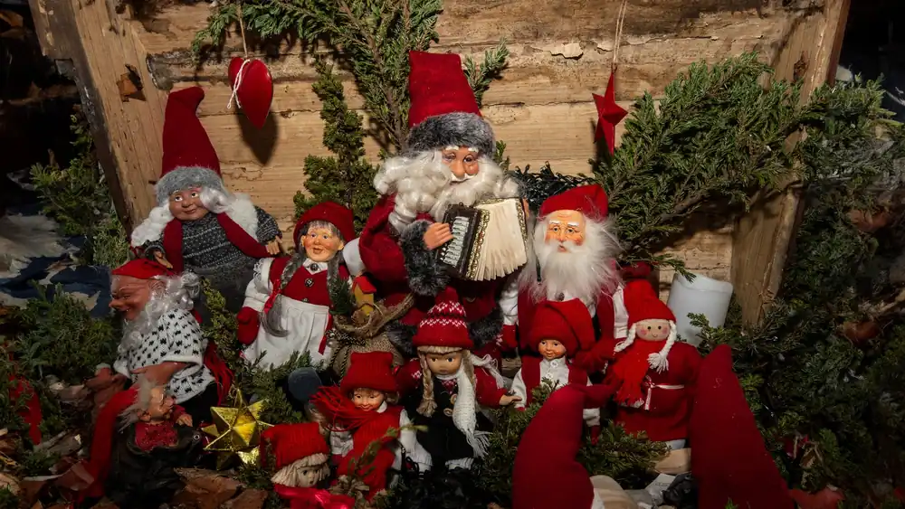 Charming Christmas elf and Santa figurines create a festive holiday scene.