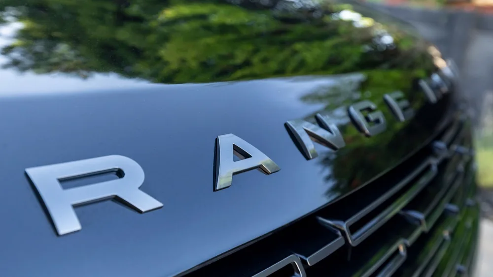 Detailed view of a Range Rover grille showcasing the elegant design of the vehicle.