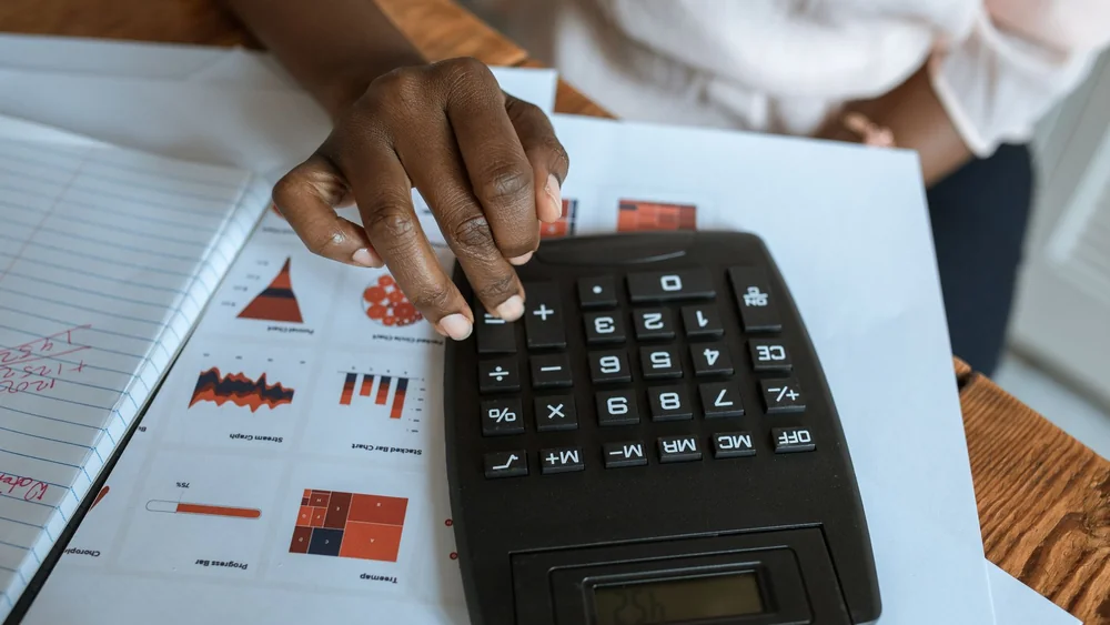 A calculator and figures used to work out monthly payments