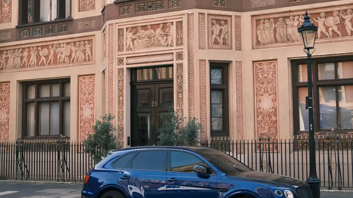 A large luxury SUV parked on a British residential street