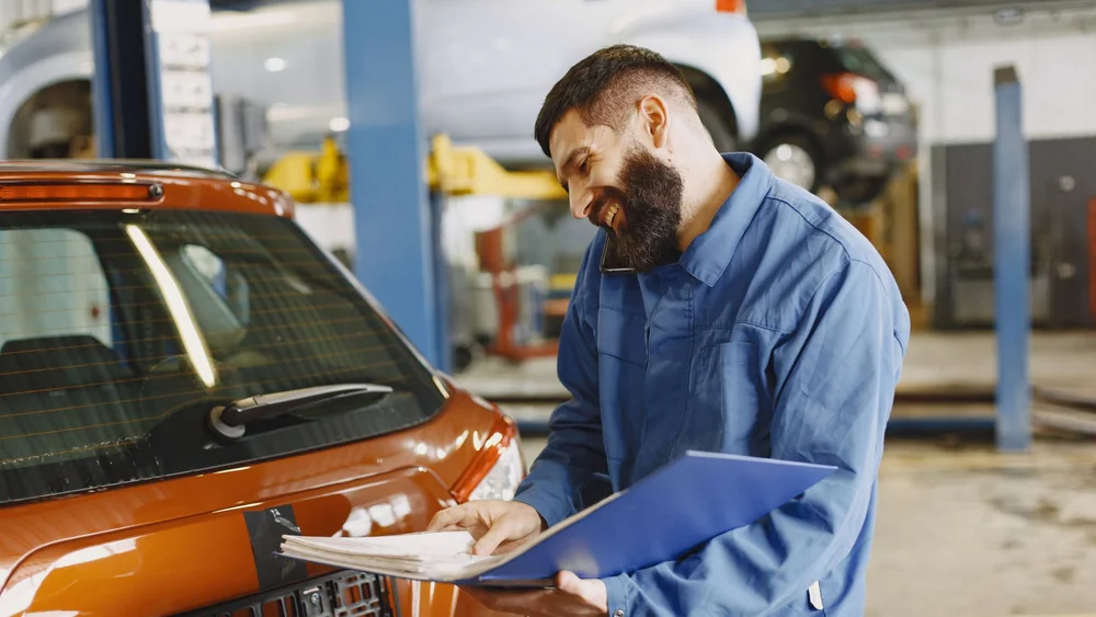 A mechanic inspecting a vehicle, the service history lenders and buyers check