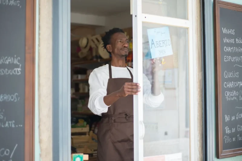 An independent shop owner opening up for the day