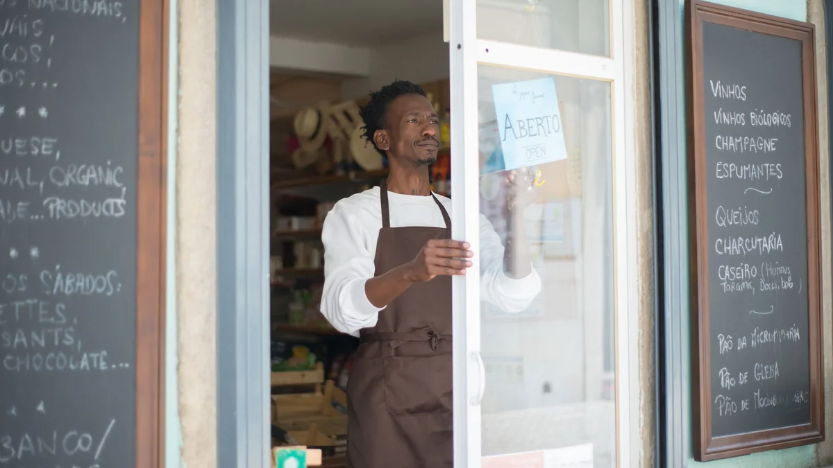 An independent shop owner opening up for the day