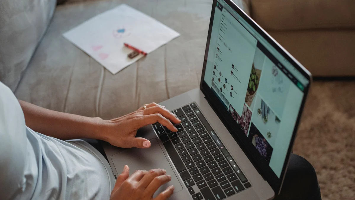 A self-employed worker completing paperwork on a laptop at home