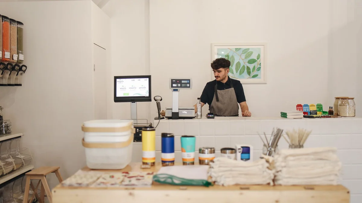A small business owner behind a shop counter