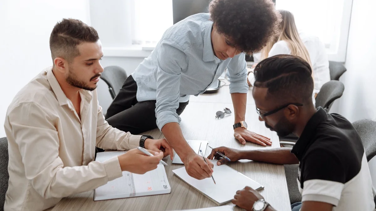 A small team working together after a business takes on staff