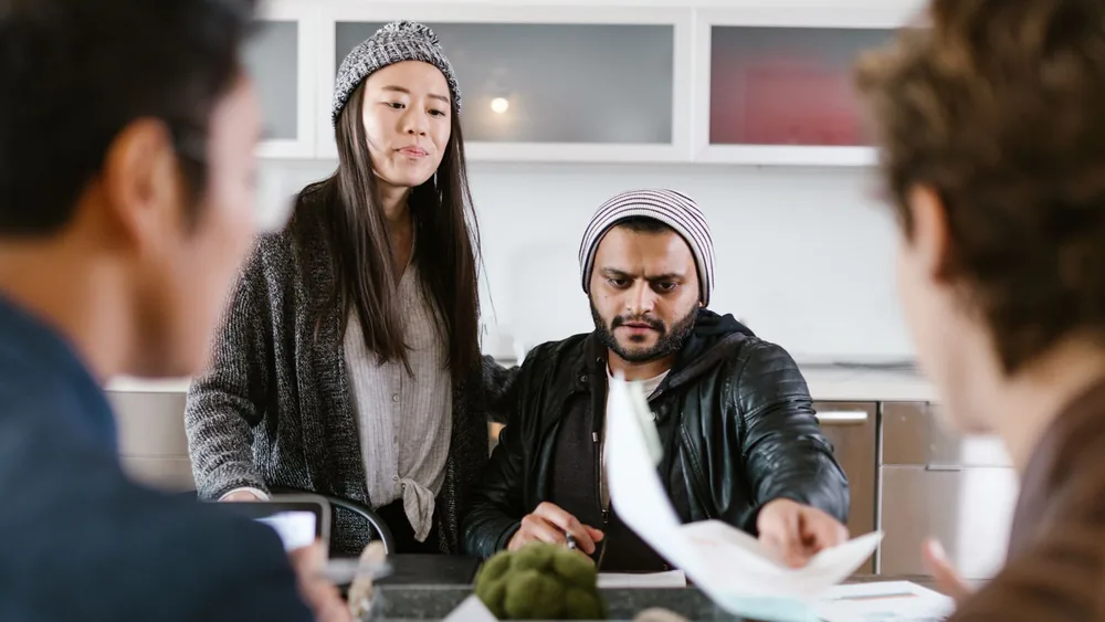 Group of young entrepreneurs brainstorming and collaborating in a modern office setting.
