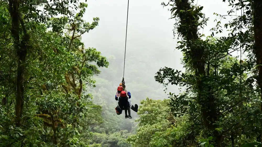 Experience an exhilarating zip line ride through the lush Costa Rican rainforest, ideal for adventure seekers.