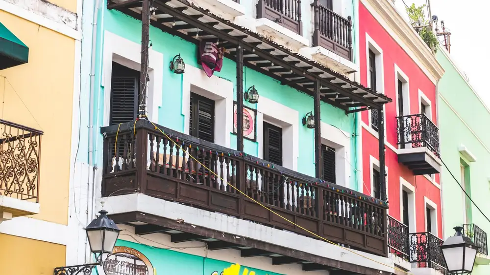 Vibrant colonial-style buildings with wooden balconies in Old San Juan, Puerto Rico.
