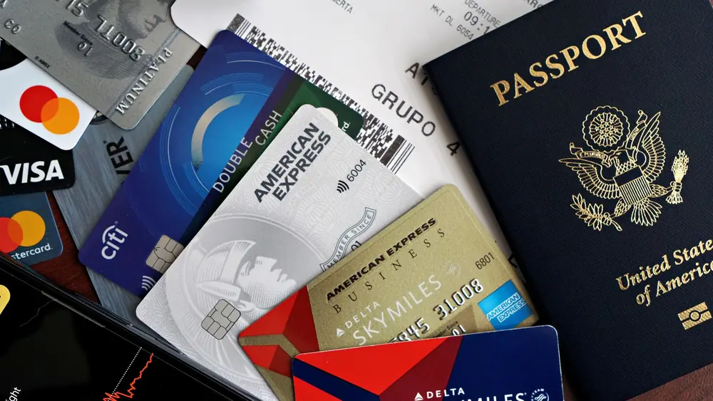 A collection of travel essentials including a passport, credit cards, and a boarding pass. Ideal for travel and finance concepts.