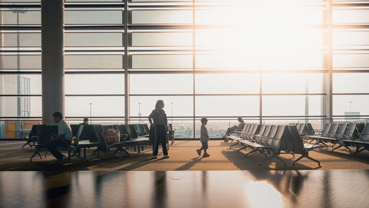 A family waiting in an airport departure terminal