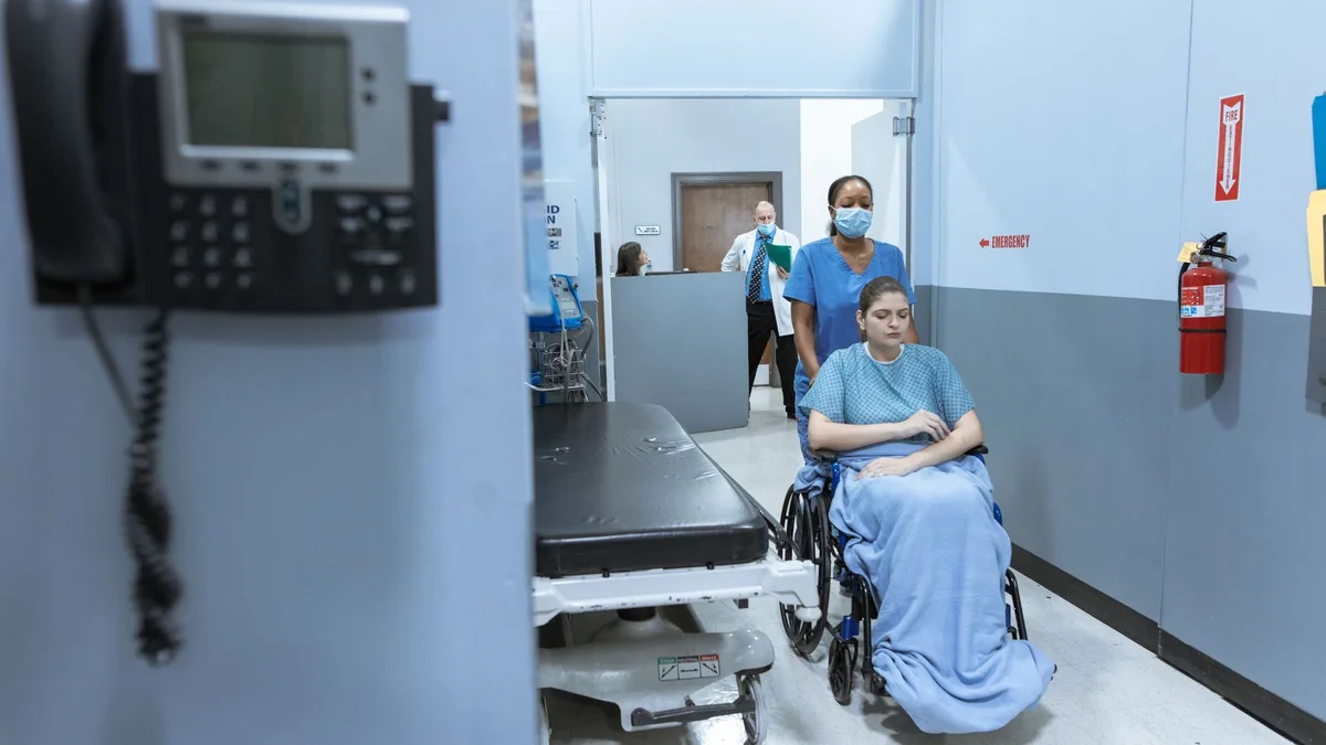 A hospital corridor, representing ongoing medical care