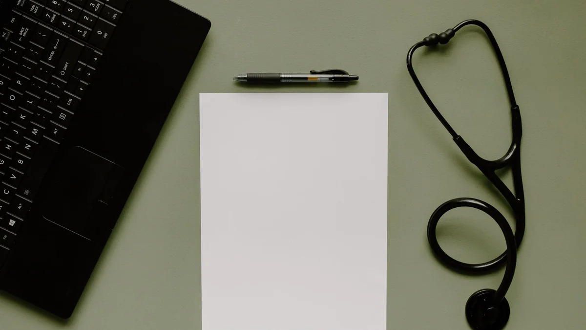 A stethoscope on a doctor examination desk