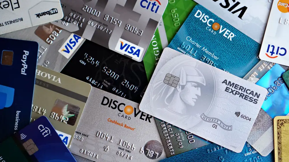 A flat lay of assorted credit and debit cards from various banks. Ideal for finance and banking concepts.
