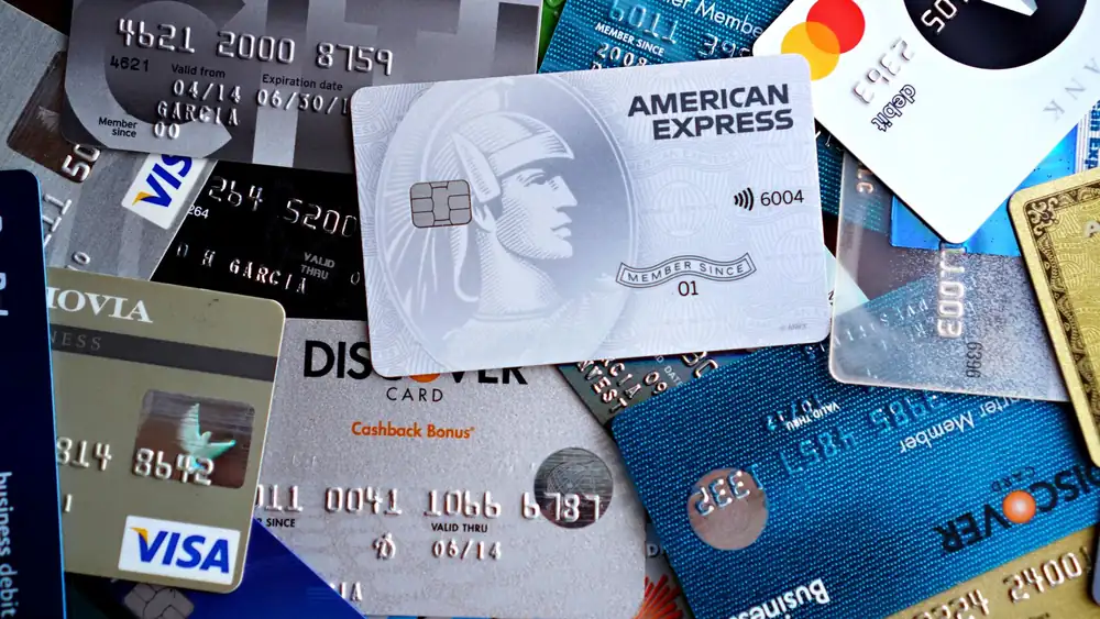 Close-up image of various credit and debit cards including Visa, MasterCard, American Express, and Discover.