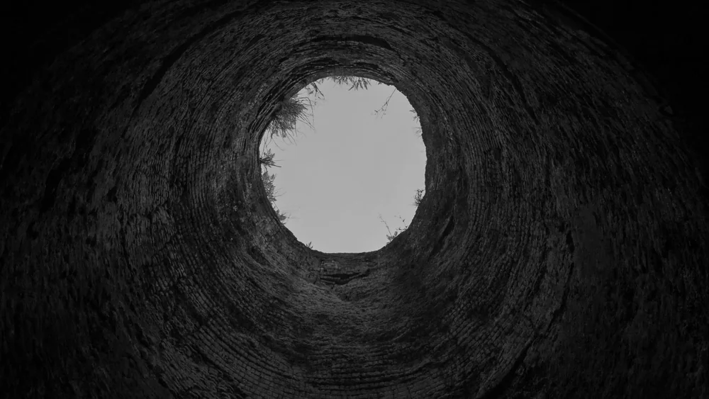 Looking up a narrow vertical shaft towards daylight